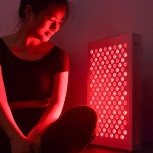 Woman with BBL2228331 red light therapy panel.