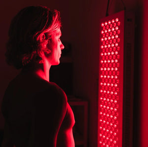 Person using red light therapy device
