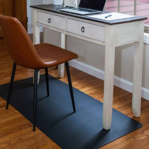 EFMO desk setup with chair, laptop, and black mat.