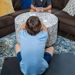 People playing cards on a coffee table