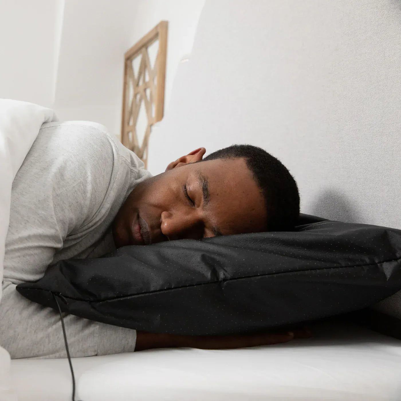 Man sleeping on Earthing Pillow Cover for grounded sleep