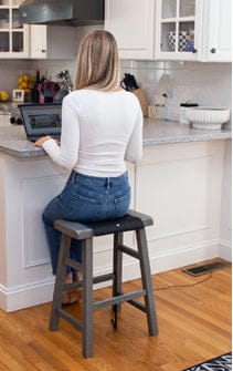 Woman working on laptop in kitchen (MAT-Small_1)