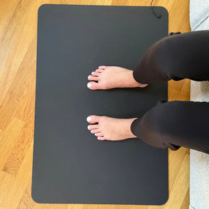 Feet on black floor mat