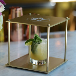 Quantum Bloc cocktail with lime and basil garnish