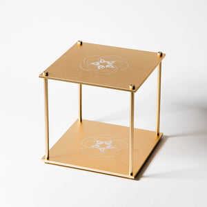 Quantum-Bloc golden cube display stand with floral design