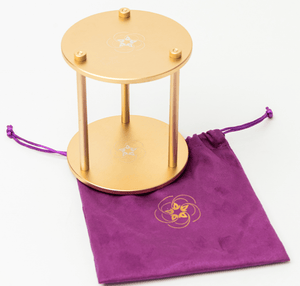 Golden device with velvet bag, screenshot from Dec 18, 2025.