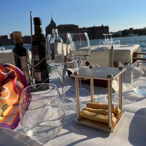 Venice restaurant table with wine glasses and Quantum Bloc hourglass