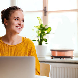 Woman smiling near WG-QiHome speaker
