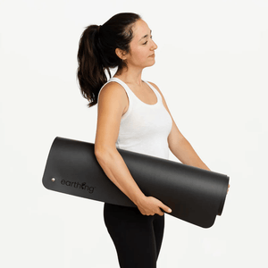 Woman holding earthing yoga mat