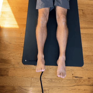 Man's legs on earthing yoga mat