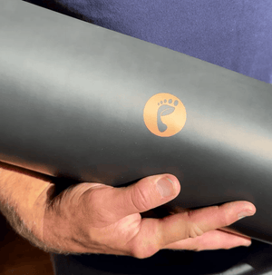 Earthing yoga mat held, logo visible