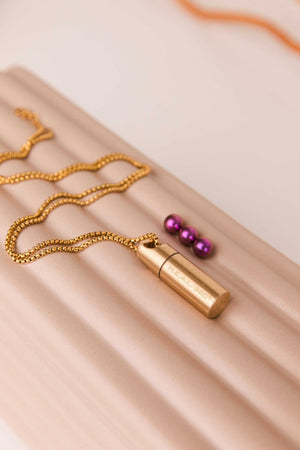 Petite gold capsule necklace with purple beads