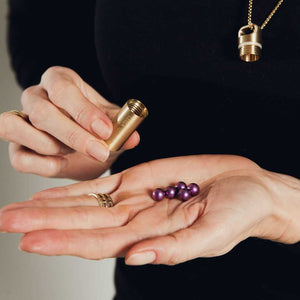Heal capsule necklace with purple pills