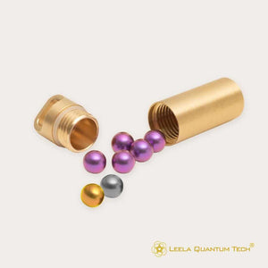 Gold tube with scattered metallic spheres.