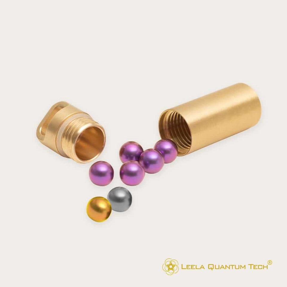 Gold tube with scattered metallic spheres.